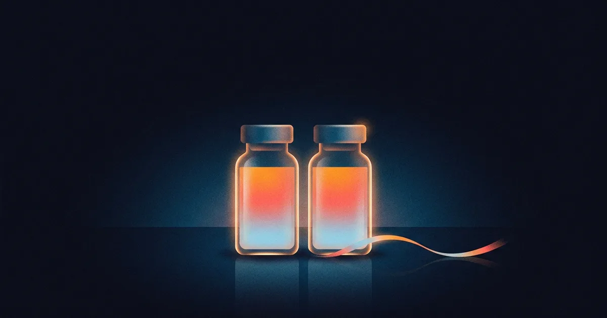 Two identical glass vials with no labels, glowing on a dark background